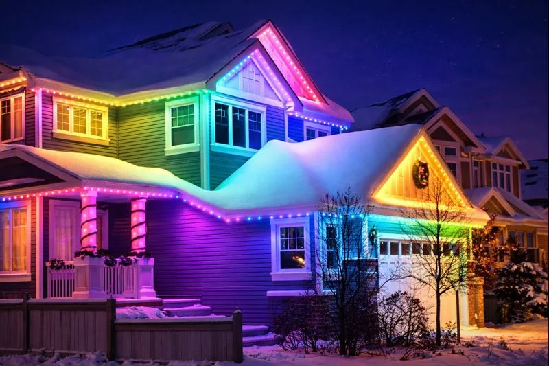 A home with multicolored lighting along its roofline
